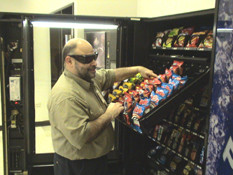 Ron Eshoo Checking Stock Levels in Snack Machine