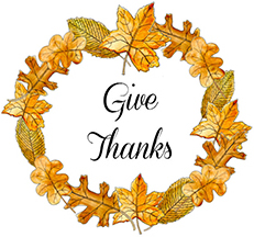 Thanksgiving wreath in orange and gold leaves with 
        the words 'Give Thanks' in the middle
